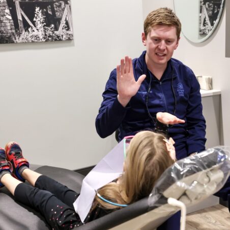 Dr. Harward waving at a young patient
